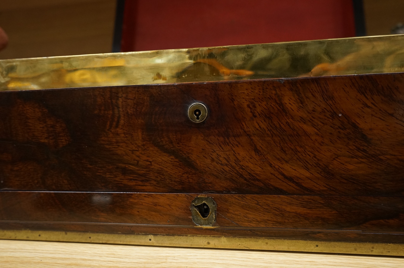 A Regency brass bound mahogany travelling tobacco box, coat of arms to centre, the inner brass cover with cedar wood lining 42.5cm wide